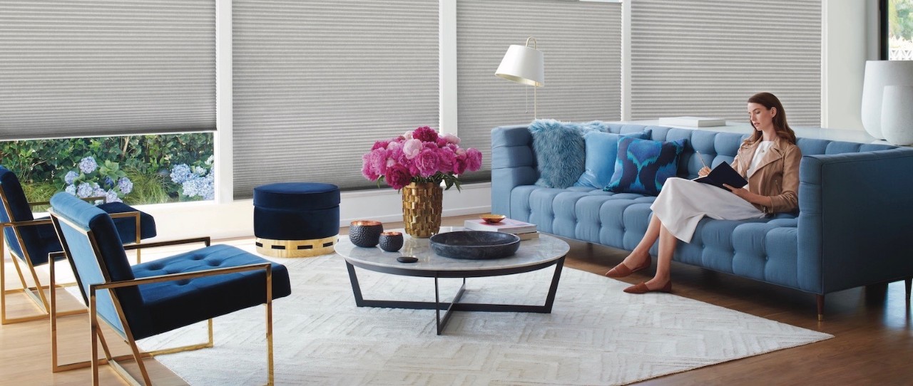 Woman sitting on blue couch in living room